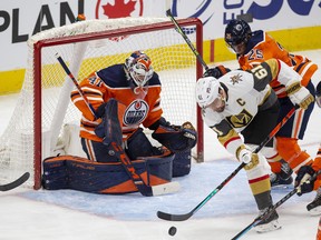 Edmonton Oilers goalie Mike Smith (41) watches as Vegas Golden Knights Mark Stone (61) battles for the puck with Darnell Nurse (25) during first period NHL action on Saturday, April 16, 2022 in Edmonton. Greg Southam-Postmedia