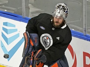 Edmonton Oilers goalie Mike Smith clears the puck during team practice in Edmonton on Tuesday, April 19, 2022.