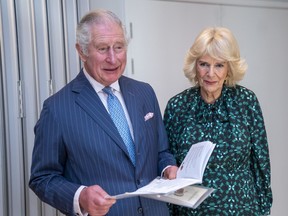 Prince Charles is flanked by Camilla, Duchess of Cornwall, as he sings an Irish song during a visit to the Irish Cultural Centre in west London, to celebrate its 25th anniversary in the run-up to St. Patrick's Day, March 15, 2022.
