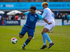 HFX Wanderers FC striker Akeem Garcia, left, is challenged for the ball by FC Edmonton defender Luke Singh in Canadian Premier League play at the Wanderers Grounds in Halifax, Nova Scotia, on Saturday, April 30, 2022.