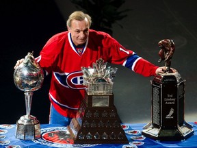 Hockey legend Guy Lafleur poses with several awards after being introduced at his farewell tour featuring the Anciens Canadiens against the Hall of Famers at Bell Centre in Montreal on Dec. 5, 2010.