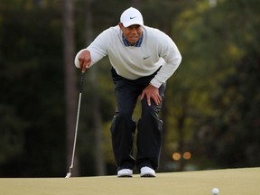 Tiger Woods lines up a putt on the 18th green during the third round of the Masters at Augusta National Golf Club, in Augusta, Georgia, on Saturday, April 9, 2022.