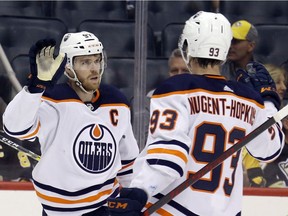 Edmonton Oilers centre Connor McDavid (97) celebrates with Ryan Nugent-Hopkins (93) after McDavid scored a power play goal against the Pittsburgh Penguins during the third period at PPG Paints Arena.