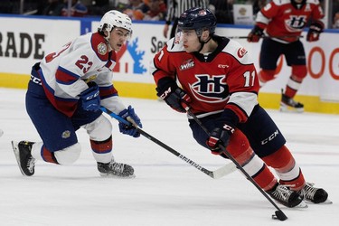 The Edmonton Oil Kings' Jalen Luypen (23) chases the Lethbridge Hurricanes' Yegor Klavdiev (11) during second period WHL playoff action at Rogers Place in Edmonton, Saturday April 23, 2022.