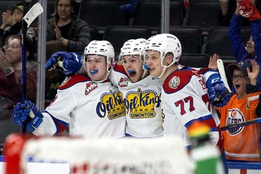 The Edmonton Oil Kings' Carson Golder (9), Jaxsen Wiebe (43) and Jakub Demek (77) celebrate a goal against the Lethbridge Hurricanes during second period WHL playoff action at Rogers Place in Edmonton, Saturday April 23, 2022.