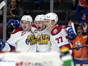 The Edmonton Oil Kings' Carson Golder (9), Jaxsen Wiebe (43) and Jakub Demek (77) celebrate a goal against the Lethbridge Hurricanes during second period WHL playoff action at Rogers Place in Edmonton, Saturday April 23, 2022.