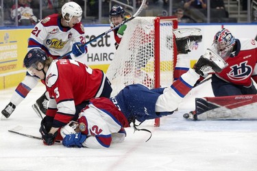 The Edmonton Oil Kings' Justin Sourdif (42) shot goes off the skate of goaltender Bryan Thomson (30) as he is checked to the ice by the Lethbridge Hurricanes' Chase Pauls (3) during first period WHL playoff action at Rogers Place in Edmonton, Saturday April 23, 2022.