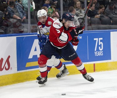 The Edmonton Oil Kings' Jakub Demek (77) battles the Lethbridge Hurricanes' Brayden Edwards (19) during first period WHL playoff action at Rogers Place in Edmonton, Saturday April 23, 2022.