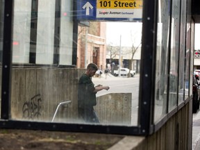 A man uses a syringe at the 101 Street South entrance to the Central LRT Station in Edmonton on Monday May 16, 2022.