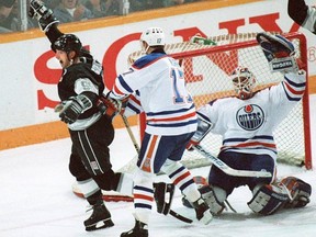 Wayne Gretzky of the Los Angeles Kings, celebrates as he scores his 1,851st point, breaking Gordie Howe's record, on Oilers goalie Bill Ranford.