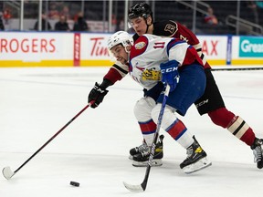 Edmonton Oil Kings' Dylan Guenther (11) battles Red Deer Rebels' Christoffer Sedoff (4) during the first period of Game 1 of their Round 2 WHL Playoffs series at Rogers Place in Edmonton, on Thursday, May 5, 2022. Guenther scored two goals in the Game 4 victory in Red Deer on Wednesday, May 11, 2022.