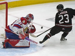 Edmonton Oil Kings goalie Sebastian Cossa makes a save on Red Deer Rebels Jhett Larson during first period WHL playoff game action in Edmonton on Saturday May 7, 2022.