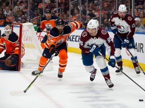 Darnell Nurse #25 of the Edmonton Oilers battles against Andre Burakovsky #95 of the Colorado Avalanche during the first period at Rogers Place on April 22, 2022.
