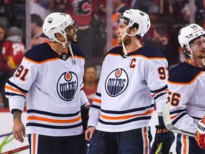Evander Kane #91 (L) and Connor McDavid #97 of the Edmonton Oilers celebrate after defeating the Calgary Flames 5-4 in overtime during game five of the second round of the 2022 Stanley Cup Playoffs at the Scotiabank Saddledome on May 26, 2022 in Calgary, Alberta, Canada.  The Flames defeated the Oilers 5-4 in overtime.