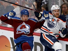 Connor McDavid (97) of the Edmonton Oilers checks Josh Manson (42) of the Colorado Avalanche in Game 1 of the Western Conference final of the 2022 Stanley Cup playoffs at Ball Arena on May 31, 2022, in Denver, Colo.