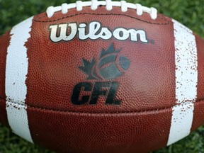 CFL logo on an official Canadian CFL league ball during warm-ups before the Saskatchewan Roughriders CFL game against the Toronto Argonauts on July 11, 2013 at Rogers Centre in Toronto, Ontario, Canada.