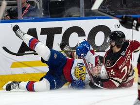 Edmonton Oil Kings’ Logan Dowhaniuk (24) is hauled down by Red Deer Rebels’ Jackson van de Leest (24), who draws a penalty, during the first period of Game 1 of their Round 2 WHL Playoffs series at Rogers Place in Edmonton, on Thursday, May 5, 2022.