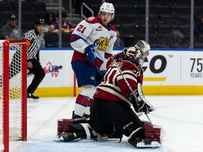 Red Deer Rebels’ goaltender Chase Coward (30) makes a save in front of Edmonton Oil Kings Jake Neighbours (21) during the first period of Game 1 of their Round 2 WHL Playoffs series at Rogers Place in Edmonton, on Thursday, May 5, 2022.
