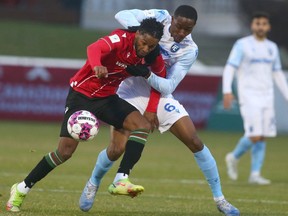 Cavalry FC Jose Escalante (L) and Edmonton Tobias Warschewski go for a ball during Canadian Championship soccer action between Cavalry FC and FC Edmonton in Calgary at ATCO Field at Spruce Meadows in Calgary on Tuesday, May 10, 2022.