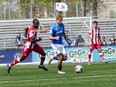 Simon Traintafillou of FC Edmonton, right, is chased by Brian Wright of Atletico Ottawa in a CPL match at Clarke Field on May 22, 2022.
