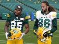 Edmonton Elks running back Walter Fletcher (25) and defensive back Aaron Grymes (36) unveil the team's new jerseys at Commonwealth Stadium in Edmonton on Friday May 20, 2022.