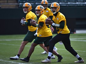 Quarterbacks Kai Locksley (10), Tre Ford (2) and Mike Beaudry (14) drop back to pass during the first day of Edmonton Elks rookie camp at Commonwealth Stadium in Edmonton on Wednesday, May 11, 2022.