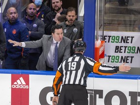 Head coach Jay Woodcroft has a word with an official after Edmonton Oilers goaltender Mike Smith (41) was pushed over by Calgary Flames forward Milan Lucic (17) on Sunday, May 22, 2022 in Edmonton.