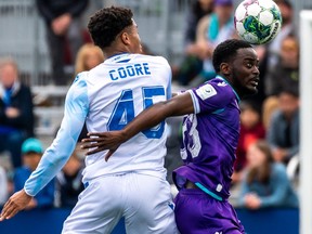 Pacific FC defender Nathan Mavila, right,  battles with FC Edmonton striker Kairo Coore, No. 45, at Starlight Stadium in Langford, B.C., on May 14, 2022.