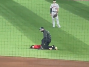 Rogers Centre security tackles a young trespasser during a recent Blue Jays game.