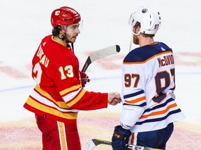 Calgary Flames forward Johnny Gaudreau (left) and Edmonton Oilers forward Connor McDavid shake hands after Game 5 of the second round of the 2022 Stanley Cup Playoffs at Scotiabank Saddledome.