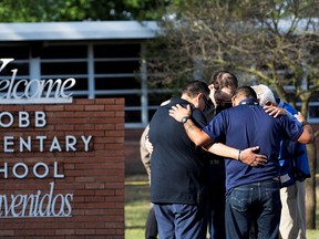 People gather at Robb Elementary School, the scene of a mass shooting in Uvalde, Texas, U.S., May 25, 2022.
