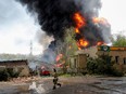 Smoke rises above a burning oil storage facility on the outskirts of Donetsk, Ukraine May 4, 2022.