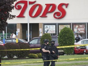 Police secure an area around a supermarket where several people were killed in a shooting, Saturday, May 14, 2022 in Buffalo, N.Y.