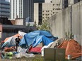 A large homeless camp has been set up along the LRT line near the Quasar Bottle Depot, 9510 105 Ave., in Edmonton Sunday May 24, 2020.