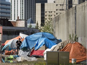 A large homeless camp has been set up along the LRT line near the Quasar Bottle Depot, 9510 105 Ave., in Edmonton Sunday May 24, 2020.