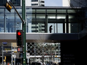 A pedestrian stops to check their cell phone in a pedway in downtown Edmonton, Thursday May 12, 2022.