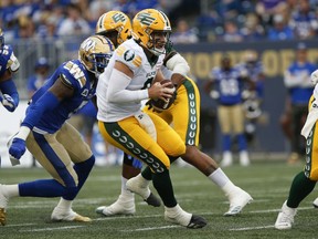Edmonton Elks quarterback Nick Arbuckle (9) looks downfield against the Winnipeg Blue Bombers during the first half of pre-season CFL action in Winnipeg on Friday, May 27, 2022.