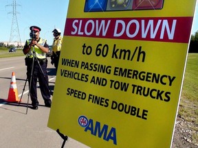 An Edmonton Police Service Constable runs laser radar at a "Give emergency crews a brake" awareness event in Edmonton on Thursday August 30, 2012.