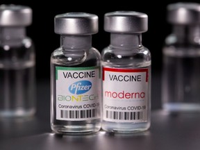 Vials with Pfizer-BioNTech and Moderna coronavirus disease (COVID-19) vaccine labels.