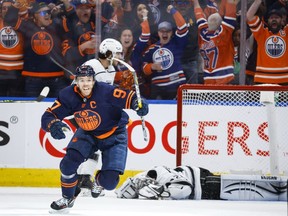 Los Angeles Kings goalie Jonathan Quick, right, lies on the ice as Edmonton Oilers centre Connor McDavid celebrates his goal during third period NHL playoff hockey action in Edmonton on Saturday, May 14, 2022.