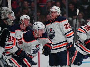 Edmonton Oilers left wing Zach Hyman (18) and defenseman Tyson Barrie (22) celebrate after a goal as LA Kings goaltender Jonathan Quick (32) reacts  in the first period of game three of the first round of the 2022 Stanley Cup Playoffs at Crypto.com Arena on May 6, 2022.