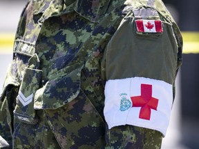 The armband of a military caregiver is seen during a ceremony marking the last day of military presence at the CHSLD Nazaire-Piche in Montreal, on Wednesday, June 17, 2020.