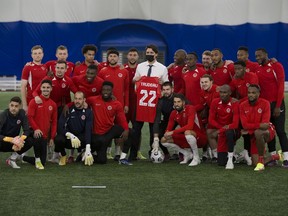 The Canadian mens national soccer team poses for a picture with Prime Minister Justin Trudeau during a practice at the Edmonton Soccer dome on Monday, Nov. 15, 2021 in Edmonton.