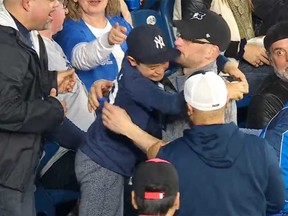 A young Yankees fan cries tears of joy after a Blue Jays fan gives him an Aaron Judge home run ball during the Yankees-Blue Jays game at Rogers Centre on Tuesday, May 3, 2022.