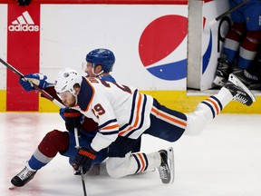 Cale Makar (8) of the Colorado Avalanche and Leon Draisaitl (29) of the Edmonton Oilers collide in Game 1 of the Western Conference final of the 2022 Stanley Cup playoffs at Ball Arena on May 31, 2022, in Denver.