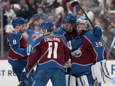 Pavel Francouz #39 of the Colorado Avalanche celebrates with Cale Makar #8, Andrew Cogliano #11 and Erik Johnson #6 after defeating the Edmonton Oilers with a score of 8 to 6 in Game One of the Western Conference Final of the 2022 Stanley Cup Playoffs at Ball Arena on May 31, 2022 in Denver, Colorado.