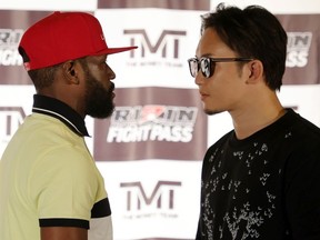Boxer Floyd Mayweather Jr. (L) and mixed martial artist Mikuru Asakura face off during a news conference announcing their exhibition boxing bout at The M Resort on June 13, 2022 in Henderson, Nevada.