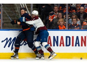 Edmonton Oilers' Jesse Puljujarvi (13) battles Colorado Avalanche's Bowen Byram (4) during third period of Game 4 of the NHL Western Conference Final action at Rogers Place in Edmonton, on Monday, June 6, 2022.
