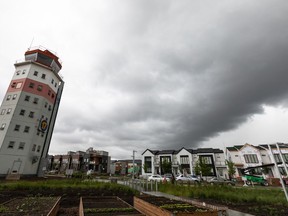 A street is seen with homes under construction, with the Blatchford control tower in the foreground