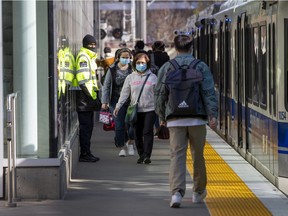 A transit security guard monitors passengers at the Health Sciences/Jubilee LRT station on April 28, 2022 in Edmonton.